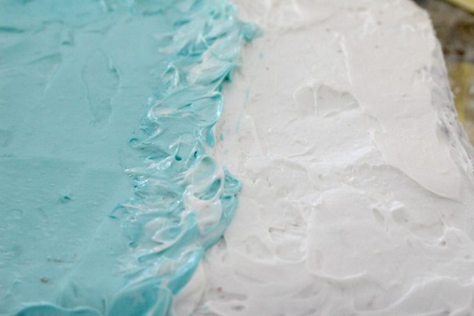 Add waves crashing to the shore to the top of the Moana cake.