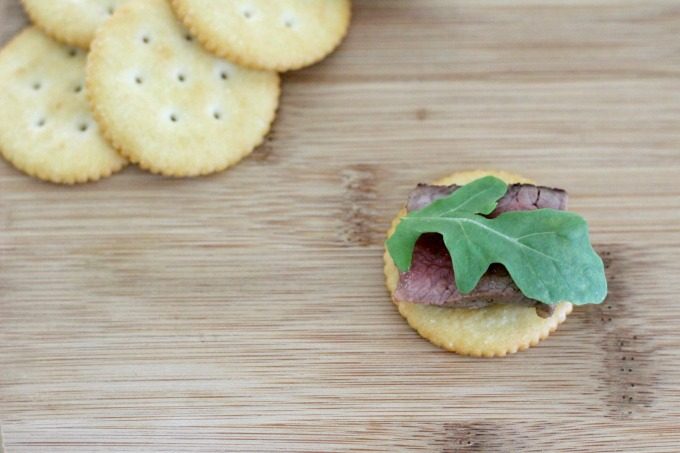 Add a leaf or two of arugula to the Party Crackers with Steak, Blue Cheese and Arugula