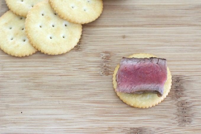 Start by topping a RITZ cracker with steak