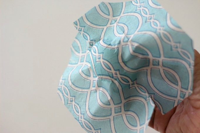 Place the napkin on the front and smooth it out for a pretty napkin wrapped Easter egg
