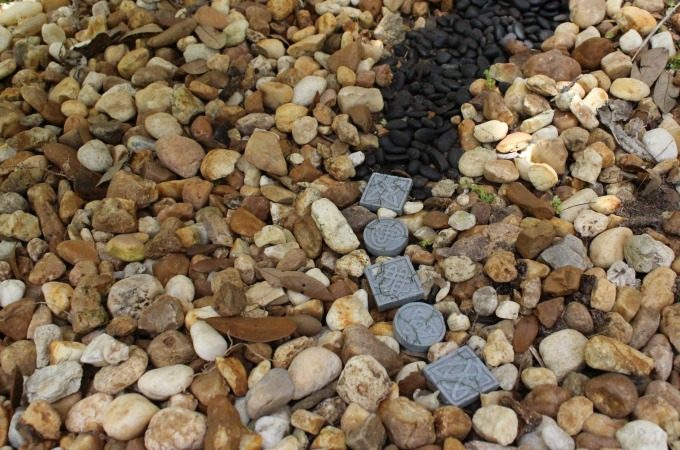Stepping stones and black pebbles formed a path.