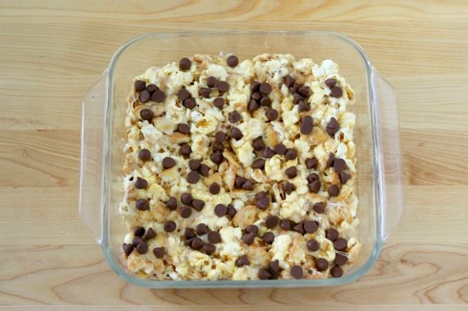 Put the marshmallow snack mix into a glass pan and add chocolate chips