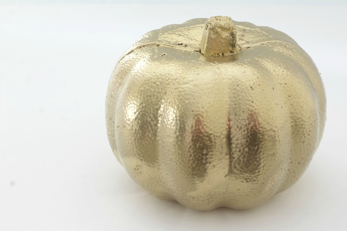 Start by painting your pumpkin with gold spray paint