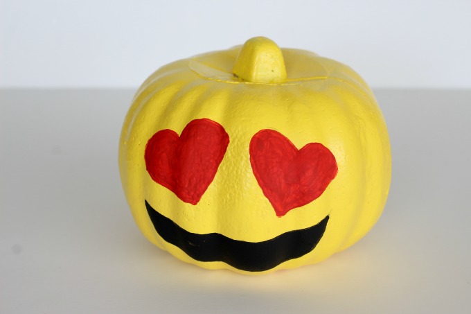You can use paint or markers for your emoji pumpkins