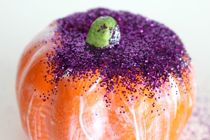 Start by covering your pumpkin with Mod Podge and sprinkling glitter over the top
