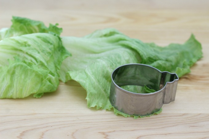 Use a cookie cutter to make round lettuce pieces for your mini veggie burger 