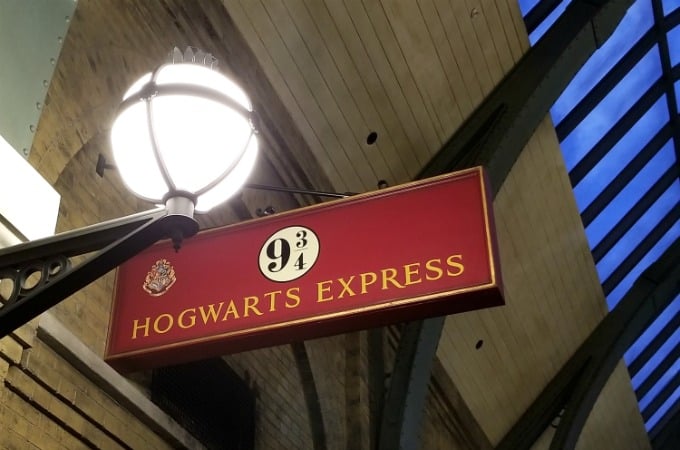 Harry Potter fans can walk through Platform 9 3/4 in the train station at The Wizarding World Of Harry Potter