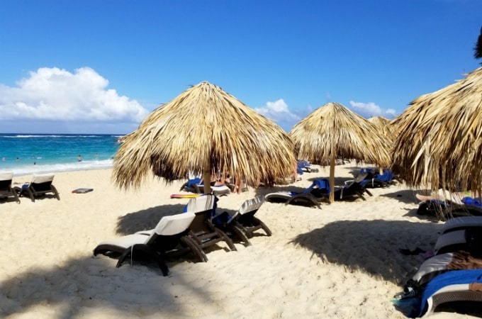 Relax under a thatched umbrella when you vacation at Memories Splash Punta Cana
