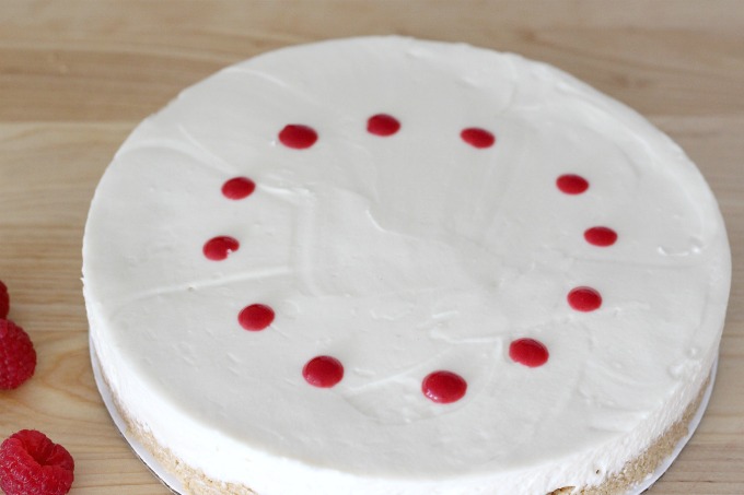 Squeeze dots of raspberry puree in a circle around the cake