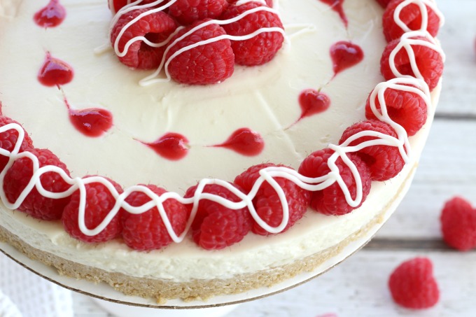 Drizzle chocolate over the raspberries and your white chocolate raspberry cheesecake is ready to serve.