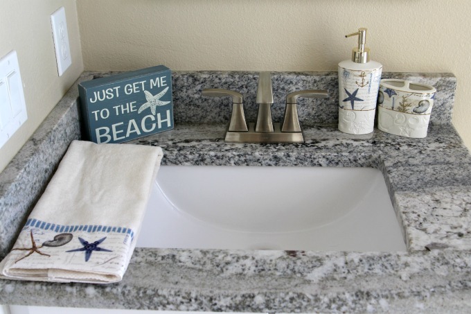 The beach sign added a nice touch to the coastal themed bathroom makeover