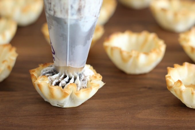 Use a decorating bag to add Oreo cheesecake to the fillo shells