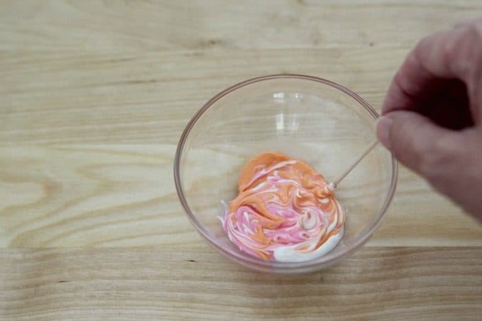 Swirling candy melts with a toothpick
