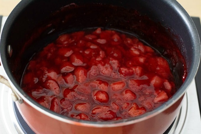 Simmering strawberries in saucepan