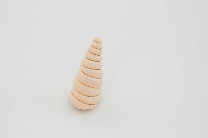Clay rolled into the shape of a unicorn horn