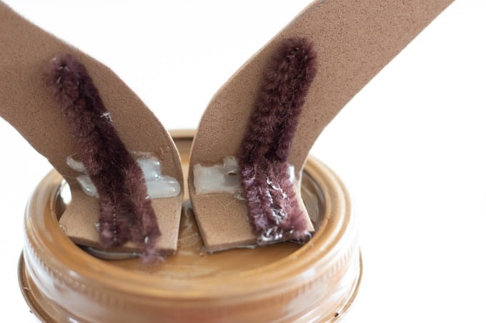 Secure antlers to your reindeer mason jar with chenille and hot glue