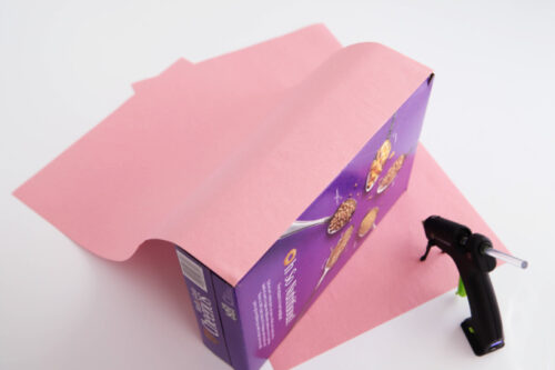 Gluing pink construction paper to valentine box
