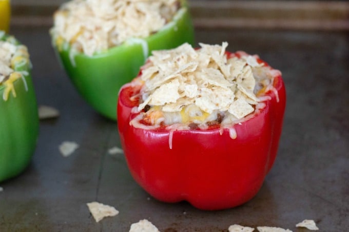 Taco stuffed peppers topped with tortillas
