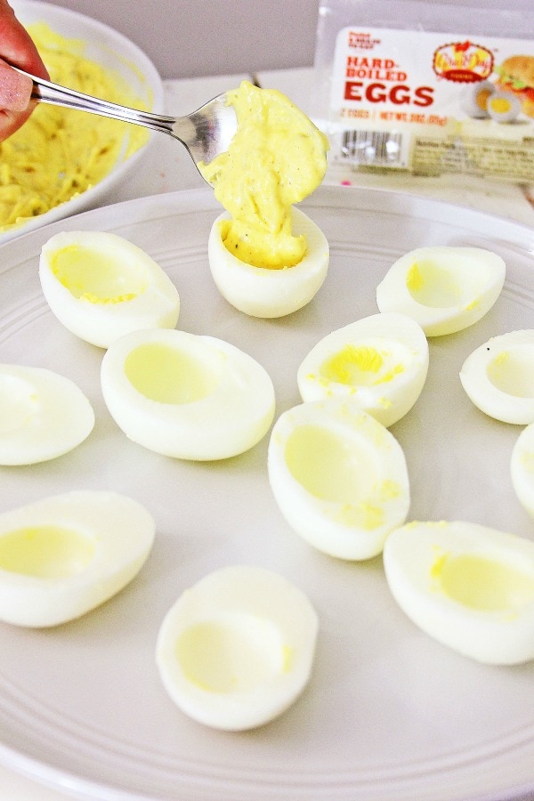 Adding yolk mixture to make deviled eggs
