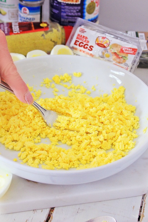 Mashing yolks for deviled eggs