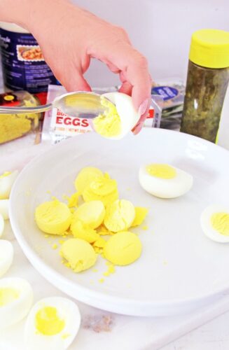 Scooping out yolks for deviled eggs