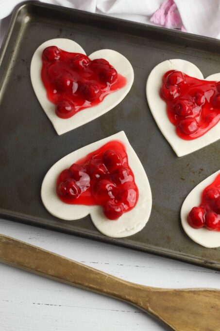 Cutting heart shaped pastry pieces