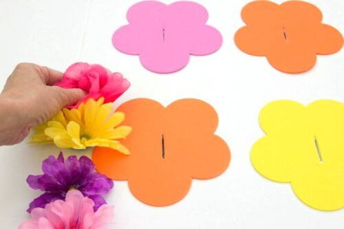 Gluing flowers to foam board for ring toss game