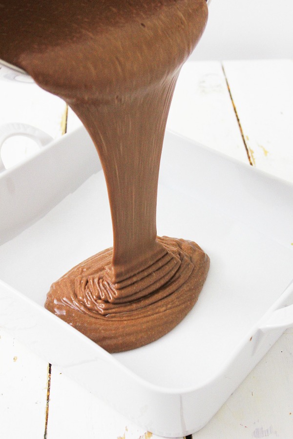 Pouring brownie batter into pan
