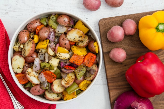 Roasted potatoes and veggies in bowl on table