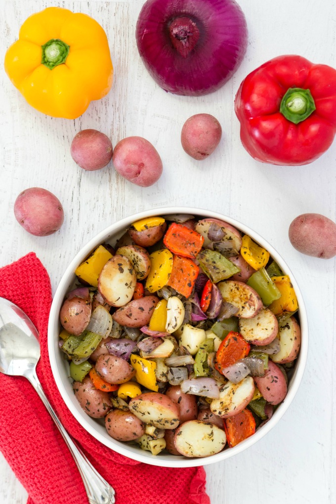 Oven roasted potatoes and vegetables in bowl with red napkin