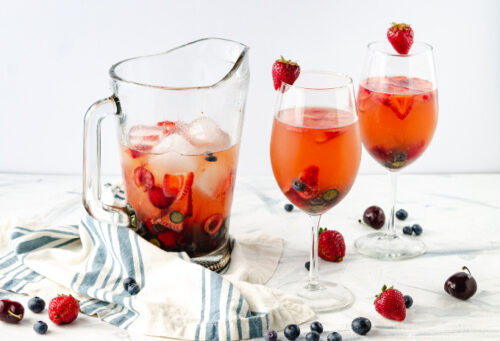 White wine sangria in a pitcher and glassware