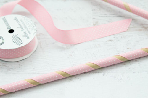 Wooden dowel wrapped in pink ribbon