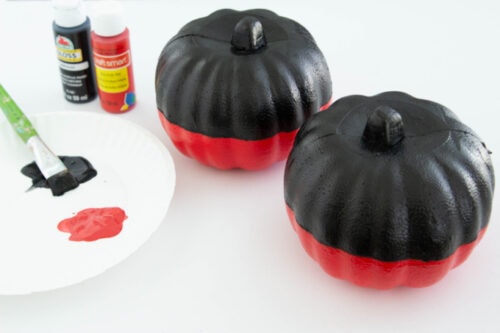 Pumpkins painted red and black