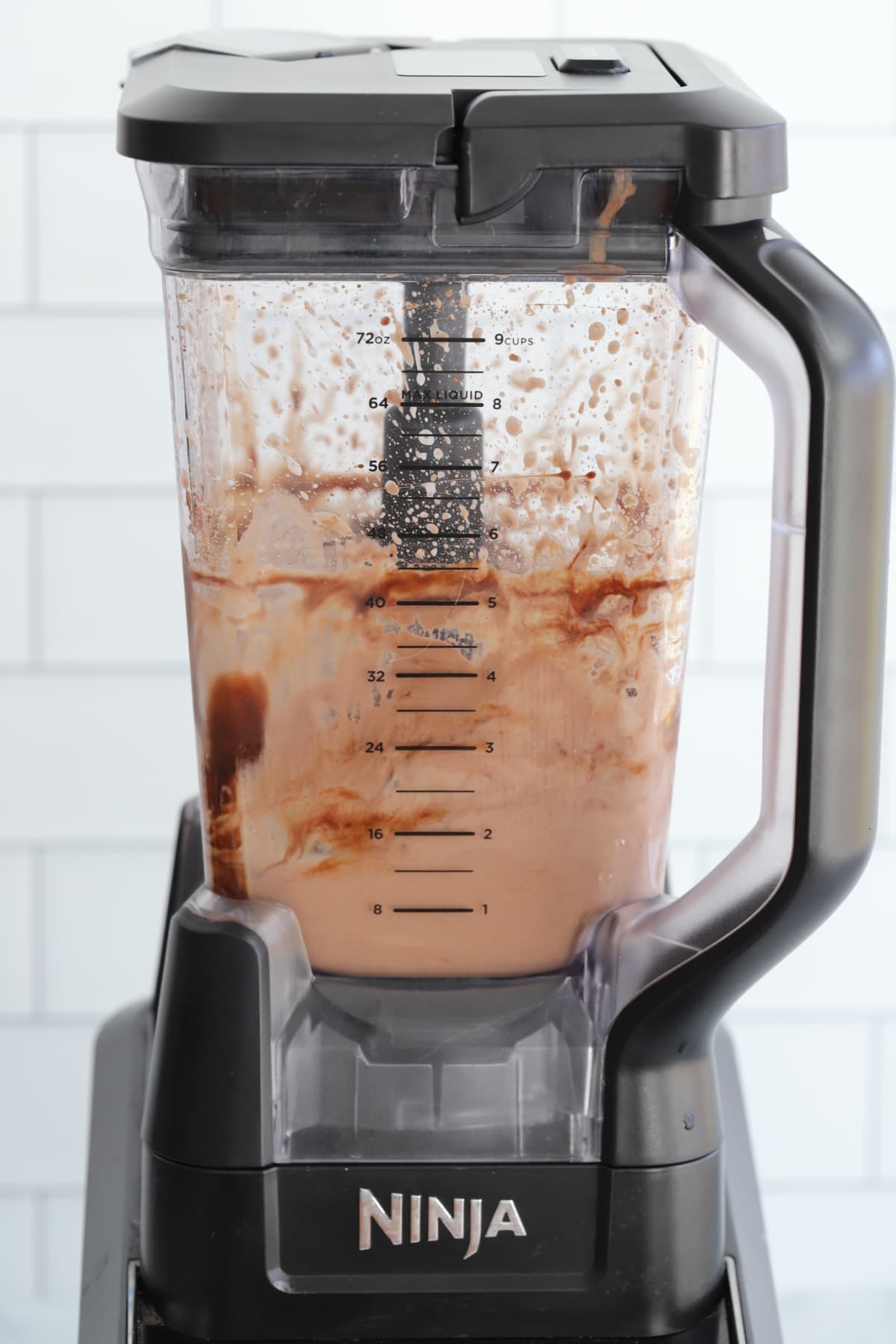 Combining chocolate milkshake ingredients in a blender