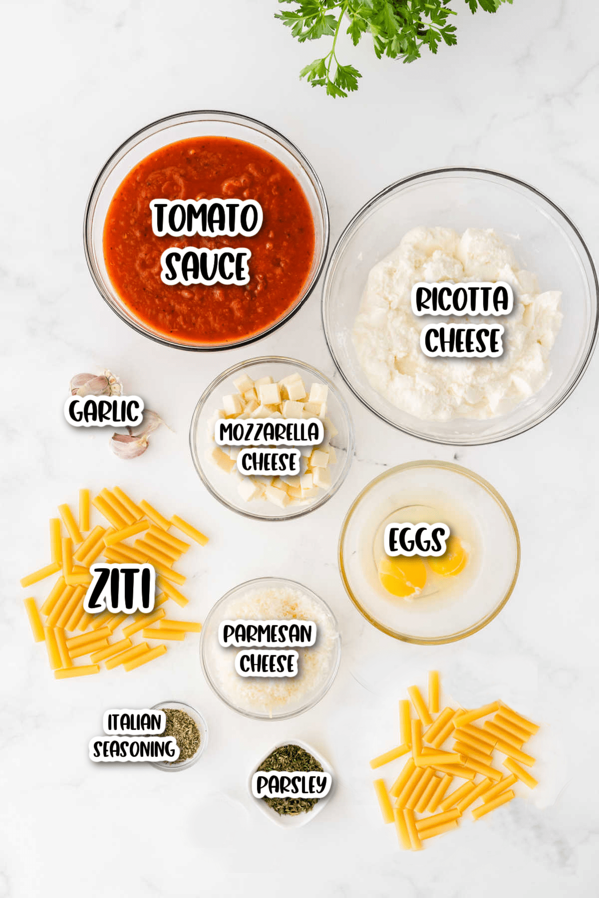 Meatless baked ziti ingredients on white background