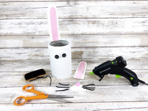 Putting together a tin can craft for Easter