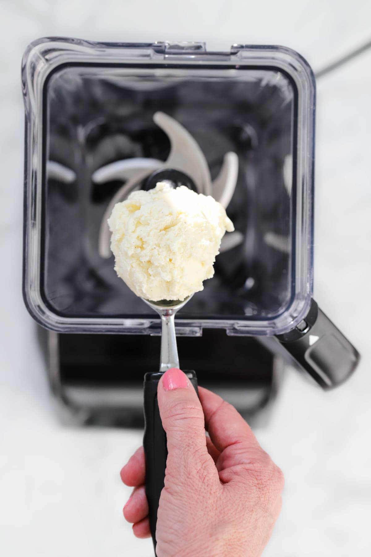 Scooping vanilla ice cream into blender