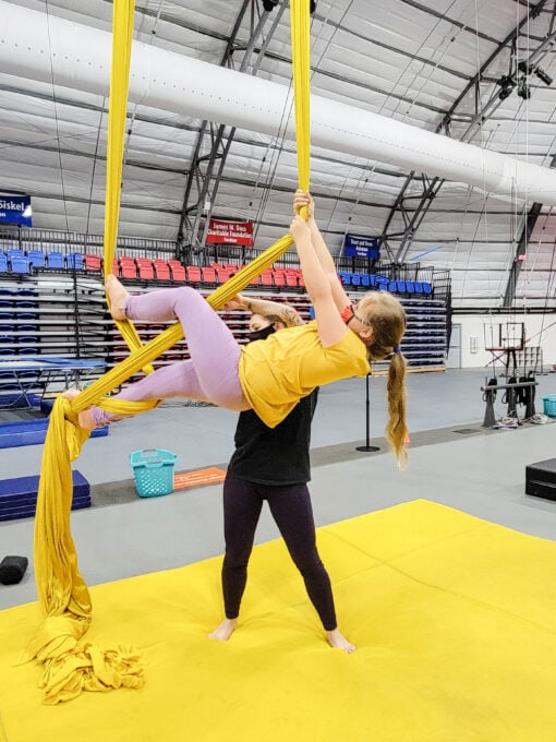 Girl doing tricks on aerial silks at the Circus Arts Conservatory