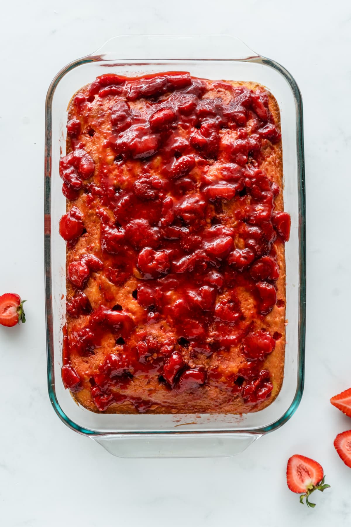 Poke cake covered with strawberry sauce