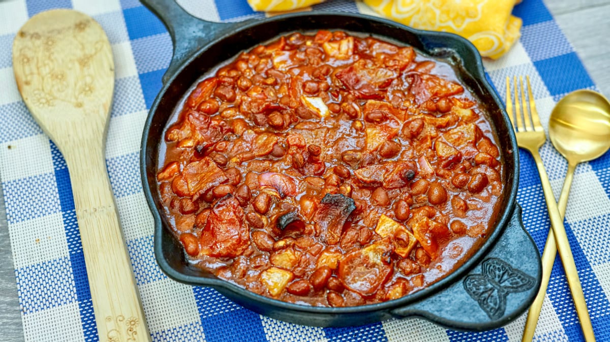 Baked beans with bacon on a checkered tablecloth