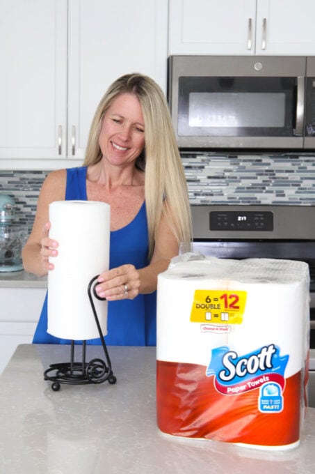 Placing roll of Scott Towels on paper towel holder