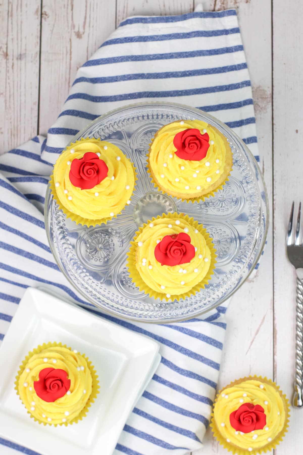 beauty and the beast cupcakes on striped towel