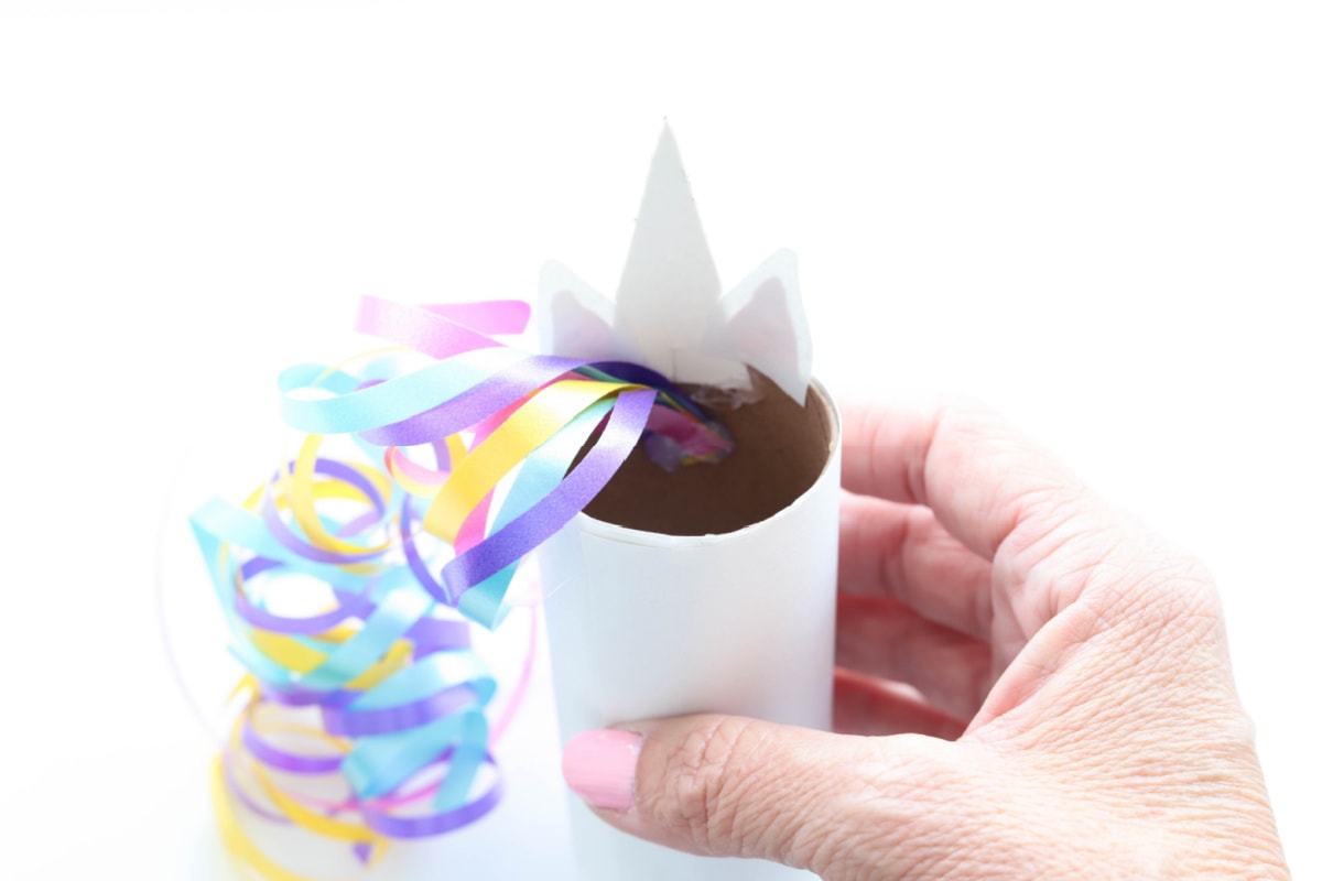 Ribbon glued to inside of toilet paper roll craft