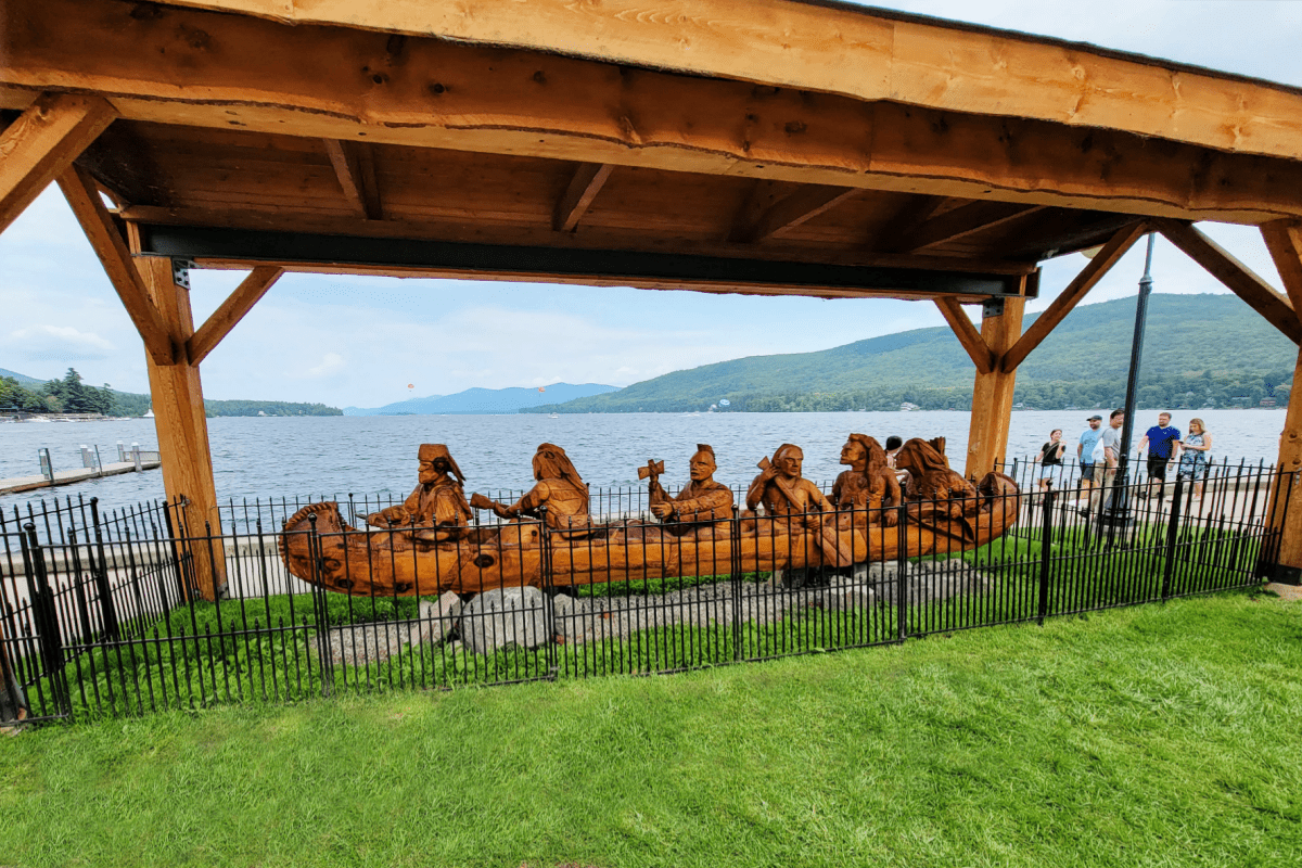 Carved wooden canoe with indians