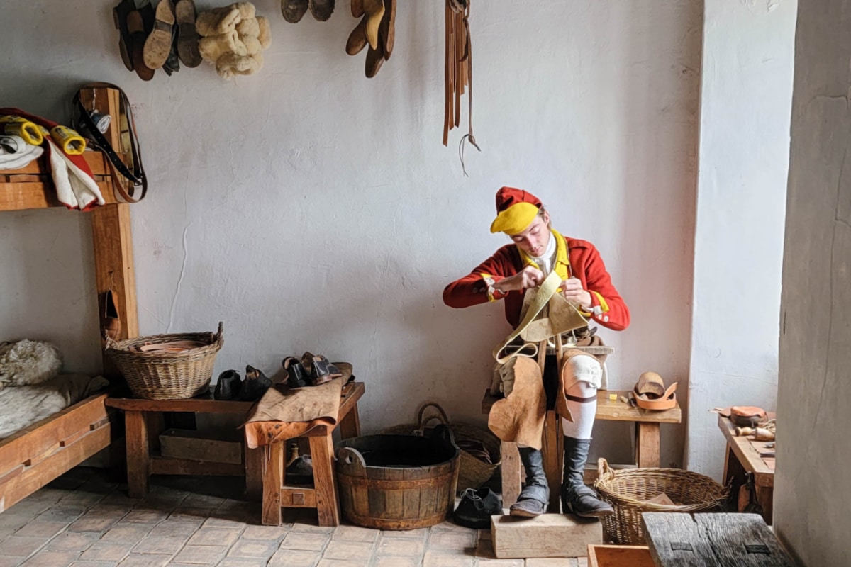 Shoemaker making shoes in an old fort bedroom