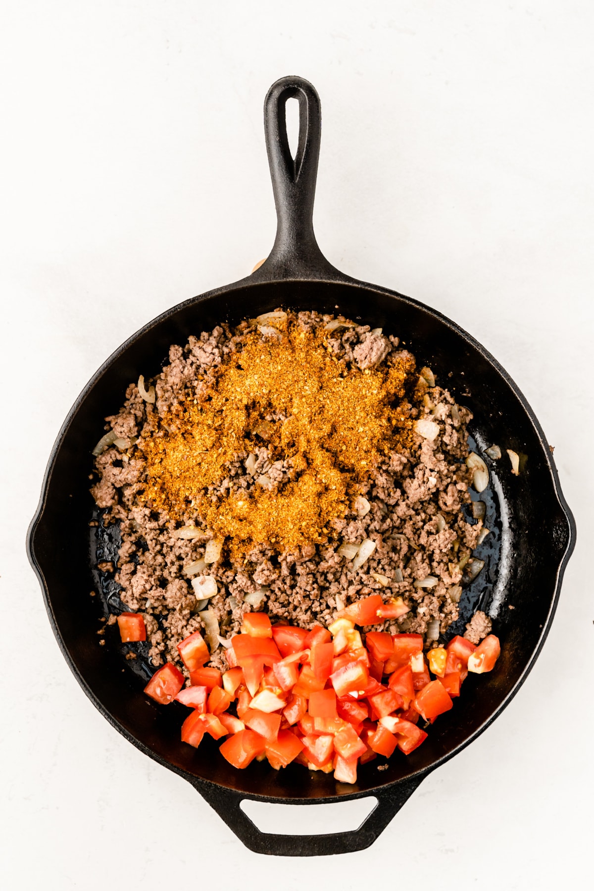Skillet with ground beef, tomatoes and taco seasoning