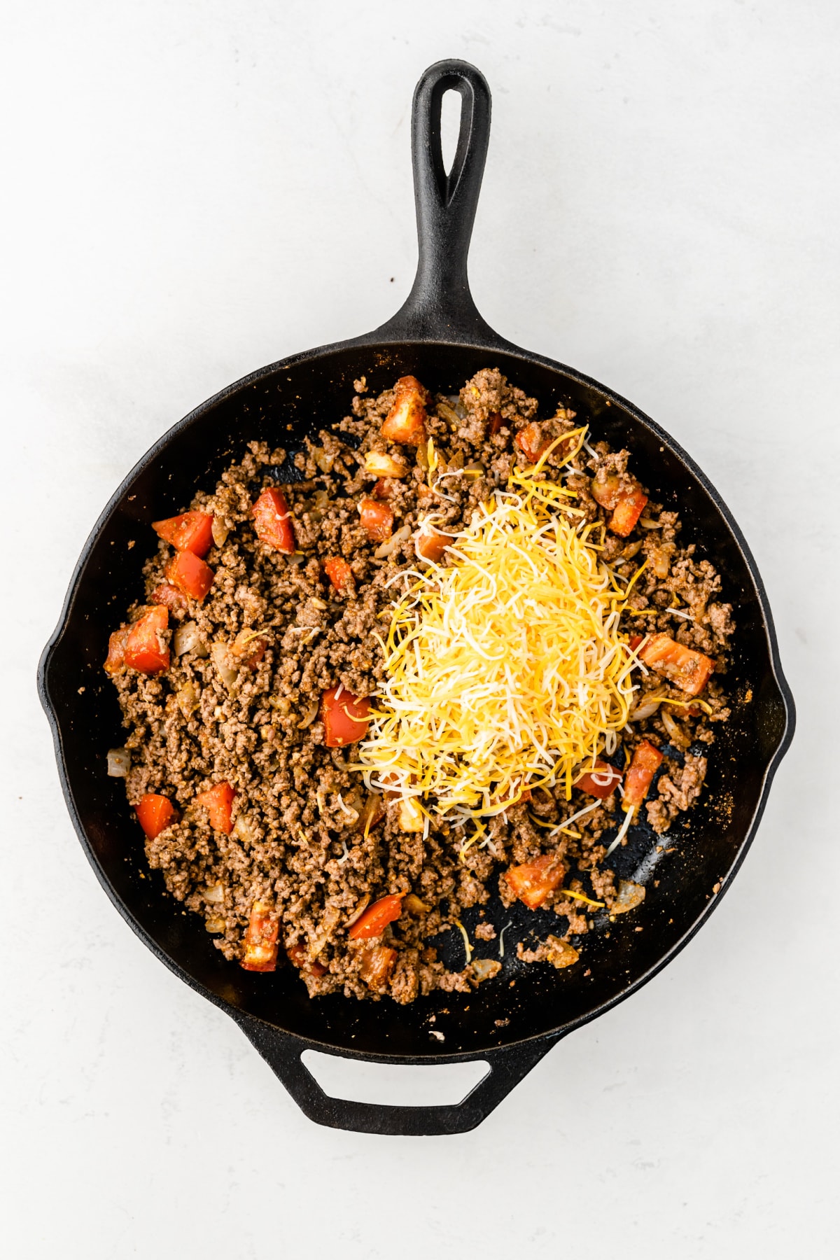 Taco meat in skillet with cheese