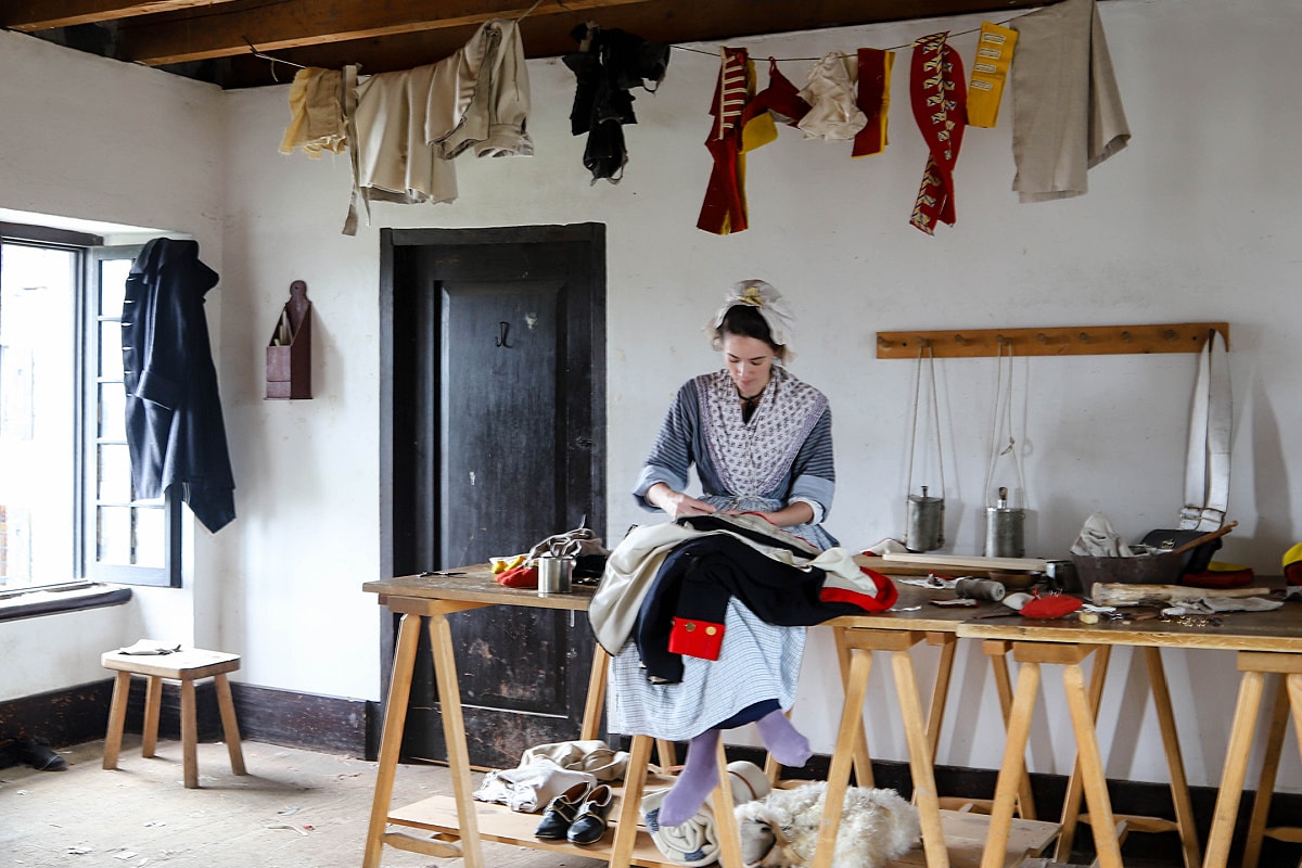 Tailor sewing uniforms at Fort Ticonderoga