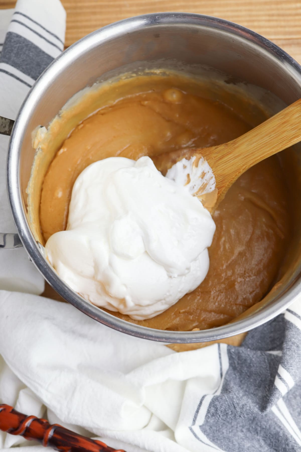 Marshmallow creme and rum extract in saucepan