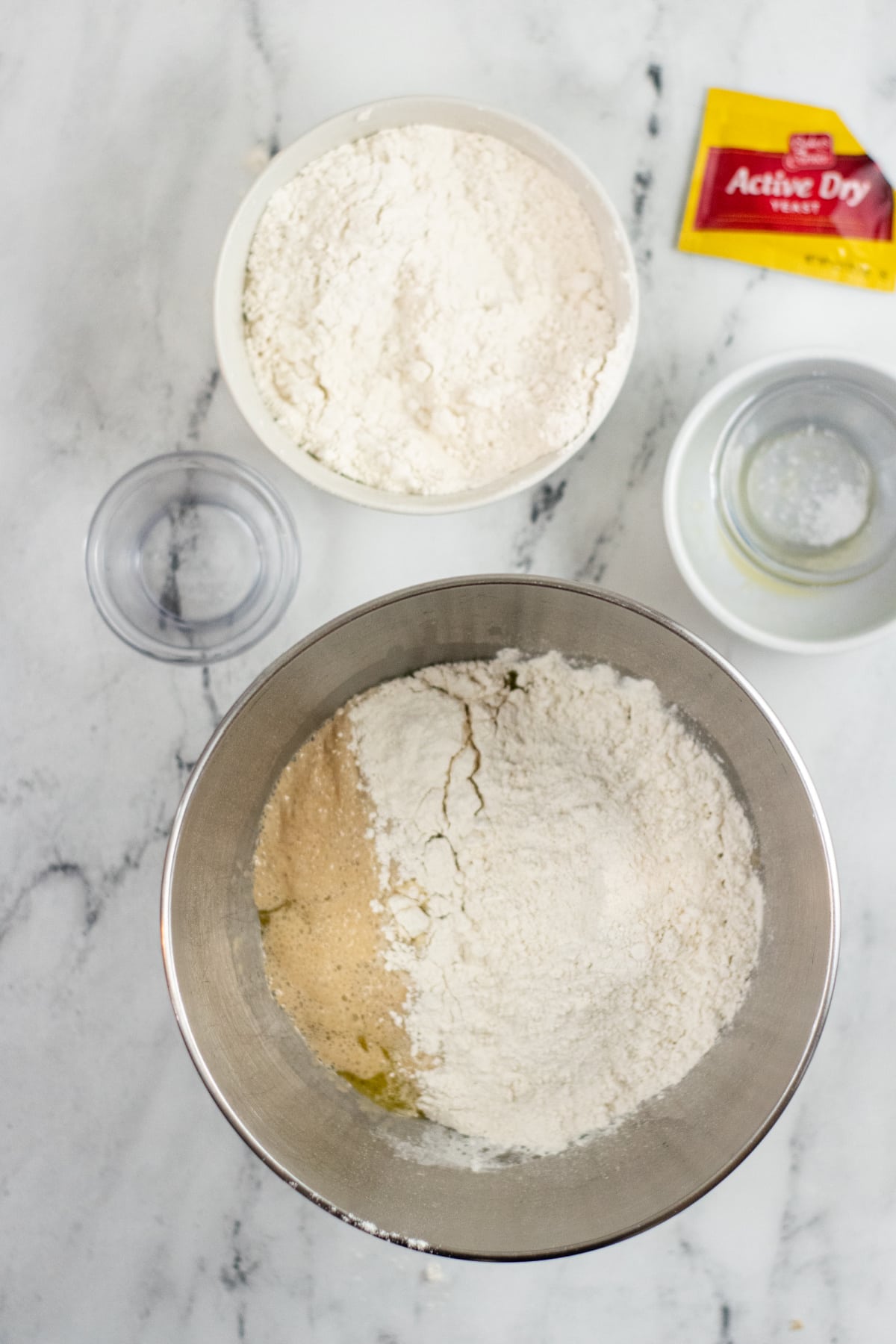 Melted butter, salt and half the flour in bowl for pretzel dogs